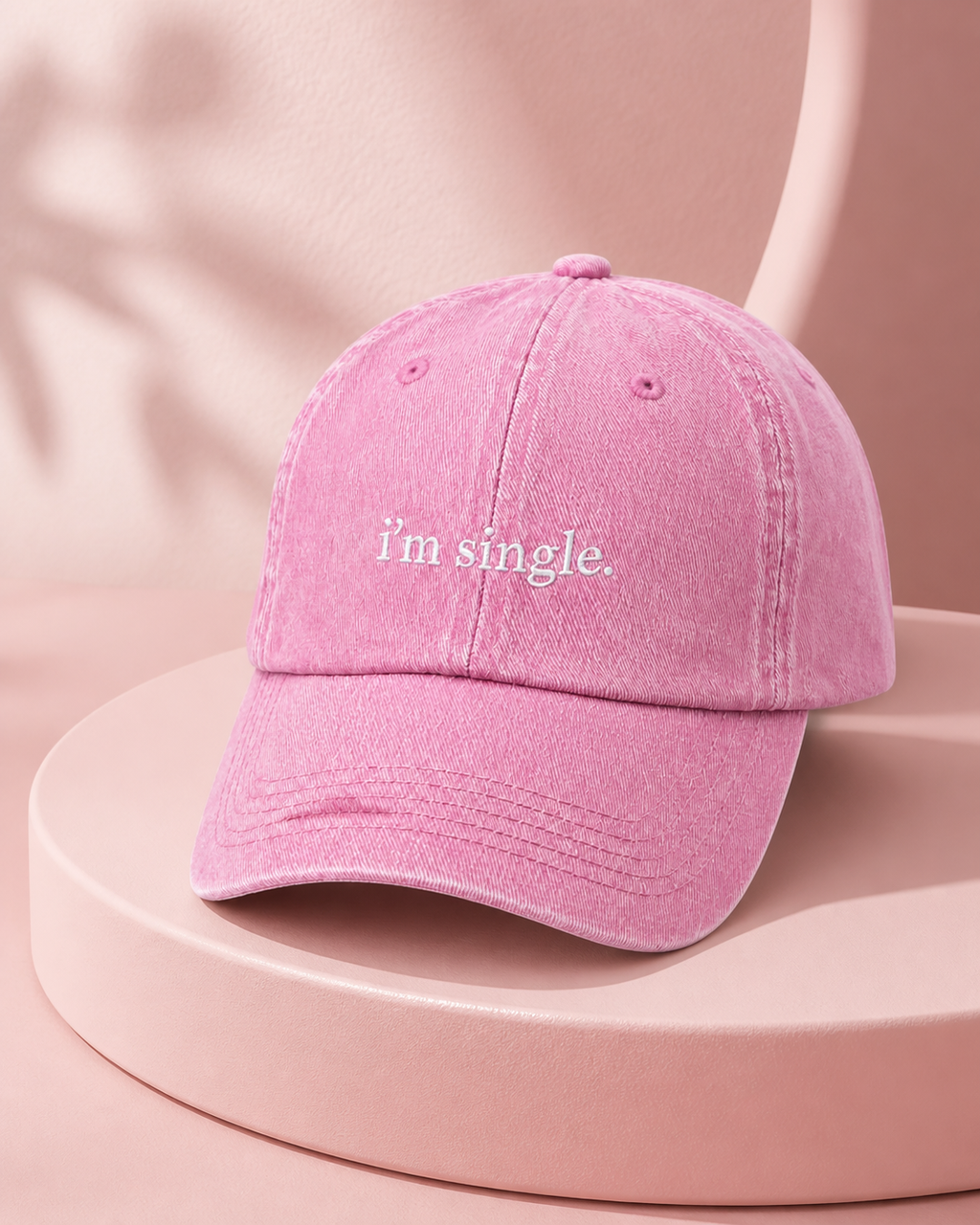 I'm Single cap in baby pink — washed cotton dad hat with “i'm single.” embroidered in white, product shot