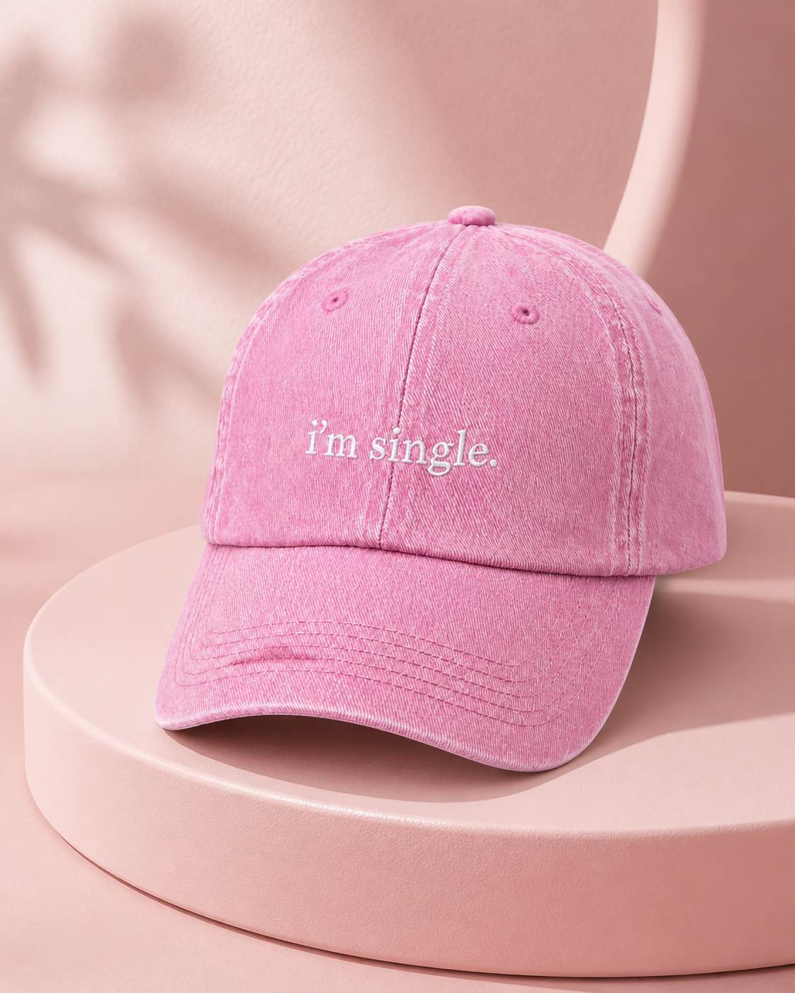 I'm Single cap in baby pink — washed cotton dad hat with “i'm single.” embroidered in white, product shot
