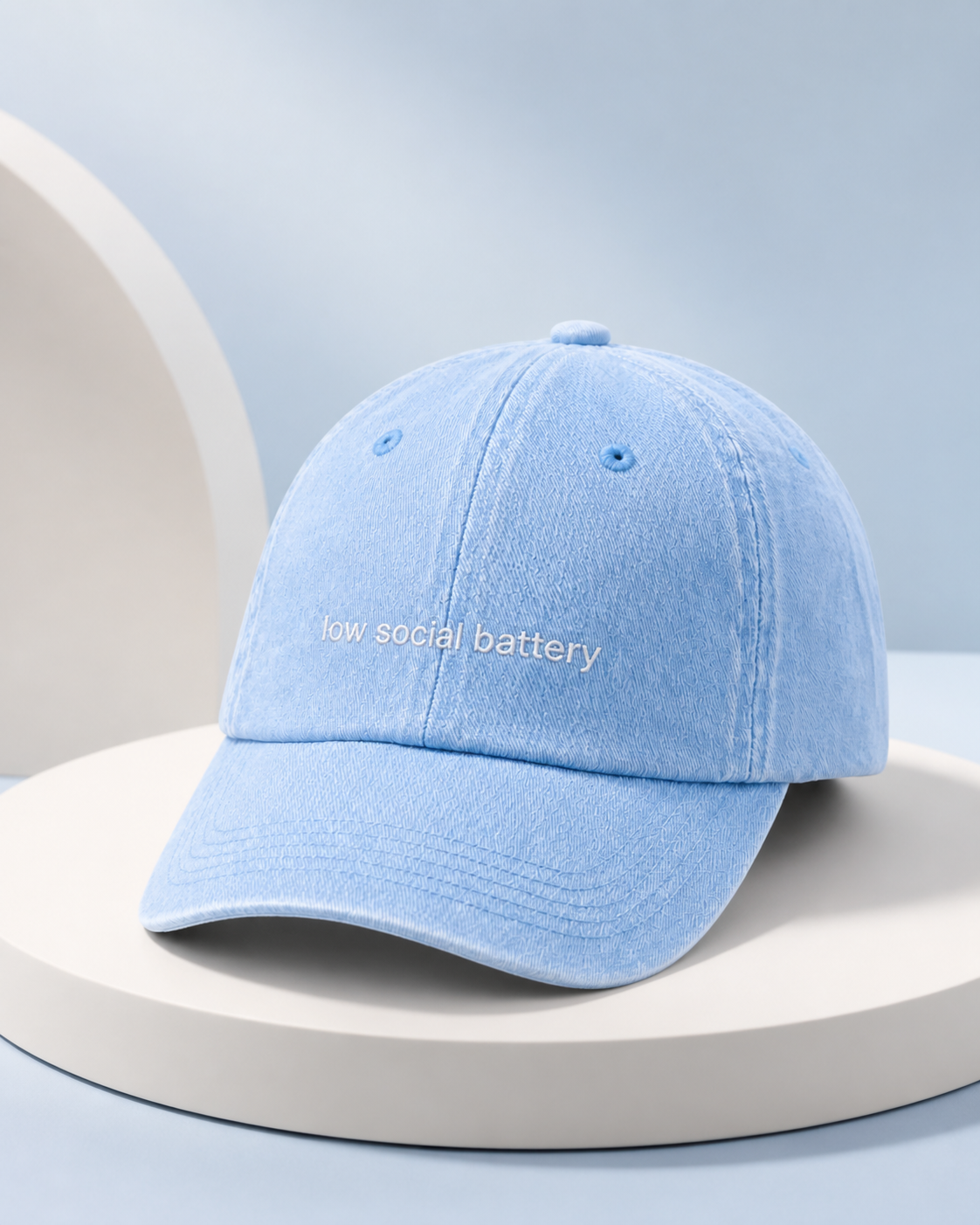 Low Social Battery cap in light blue — washed cotton dad hat with “low social battery” embroidered in white, product shot