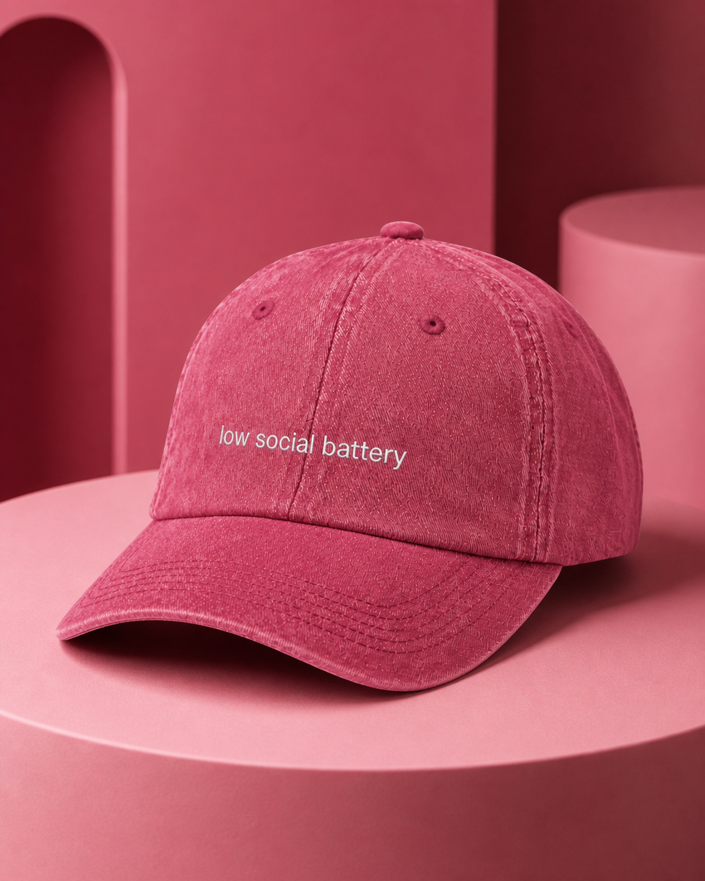 Low Social Battery cap in dark pink — washed cotton dad hat with “low social battery” embroidered in white, product shot
