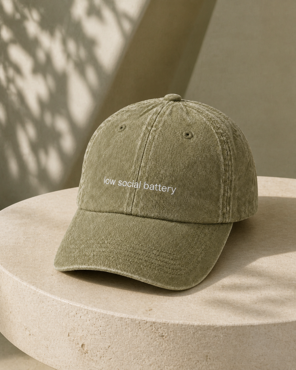 Low Social Battery cap in olive green — washed cotton dad hat with “low social battery” embroidered in white, product shot