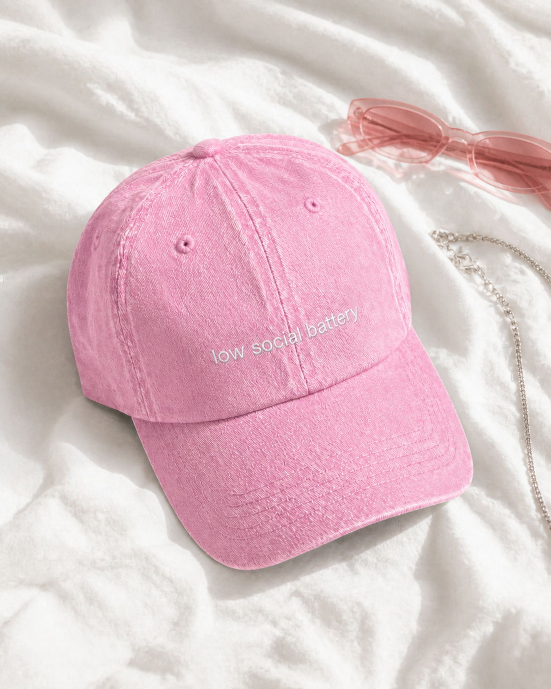 Low Social Battery cap in baby pink — washed cotton dad hat with “low social battery” embroidered in white, product shot