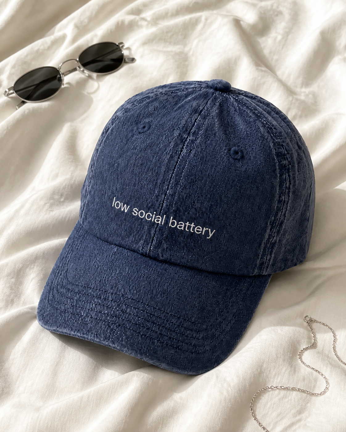 Low Social Battery cap in navy — washed cotton dad hat with “low social battery” embroidered in white, product shot