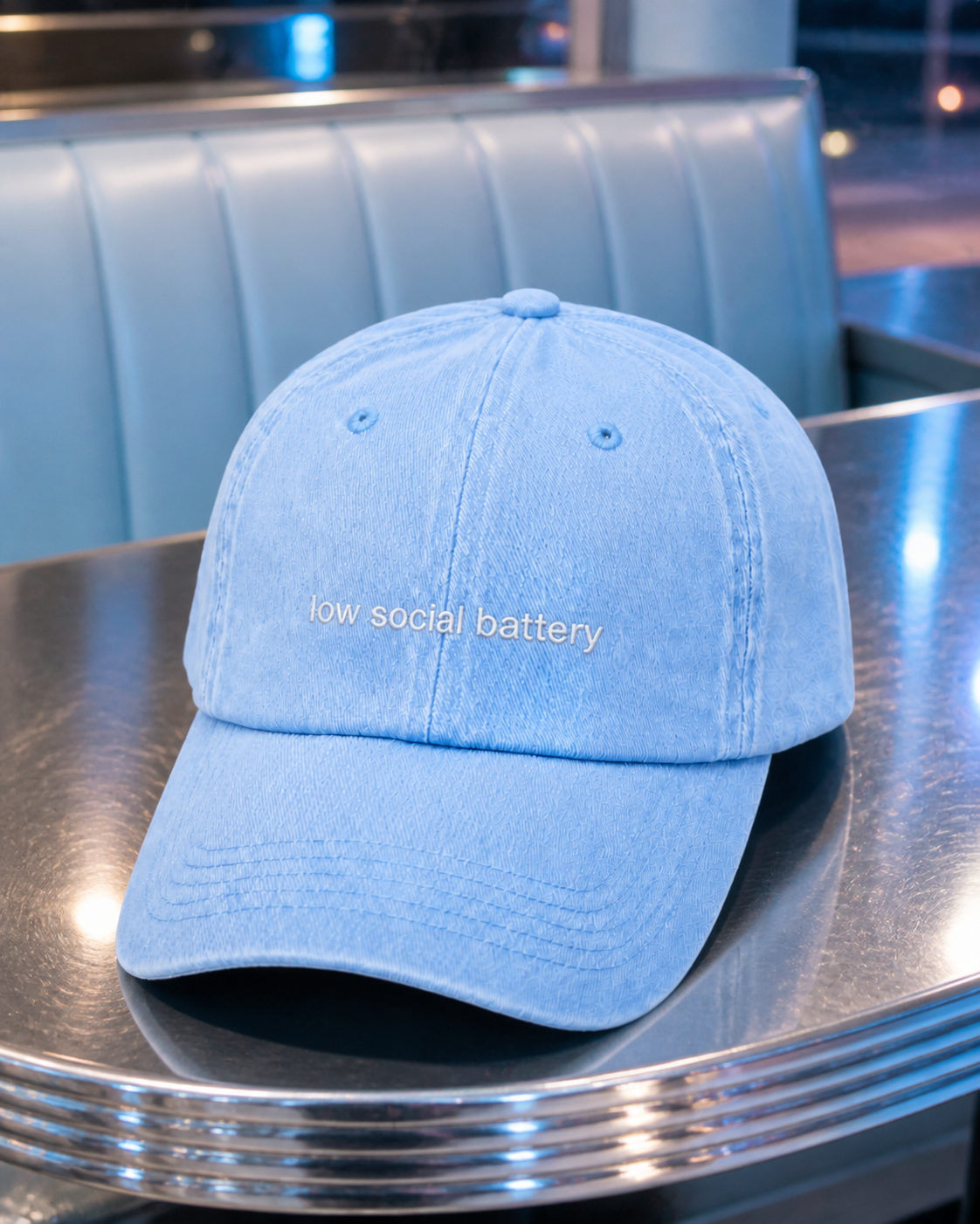 Low Social Battery cap in light blue — washed cotton dad hat with “low social battery” embroidered in white, worn