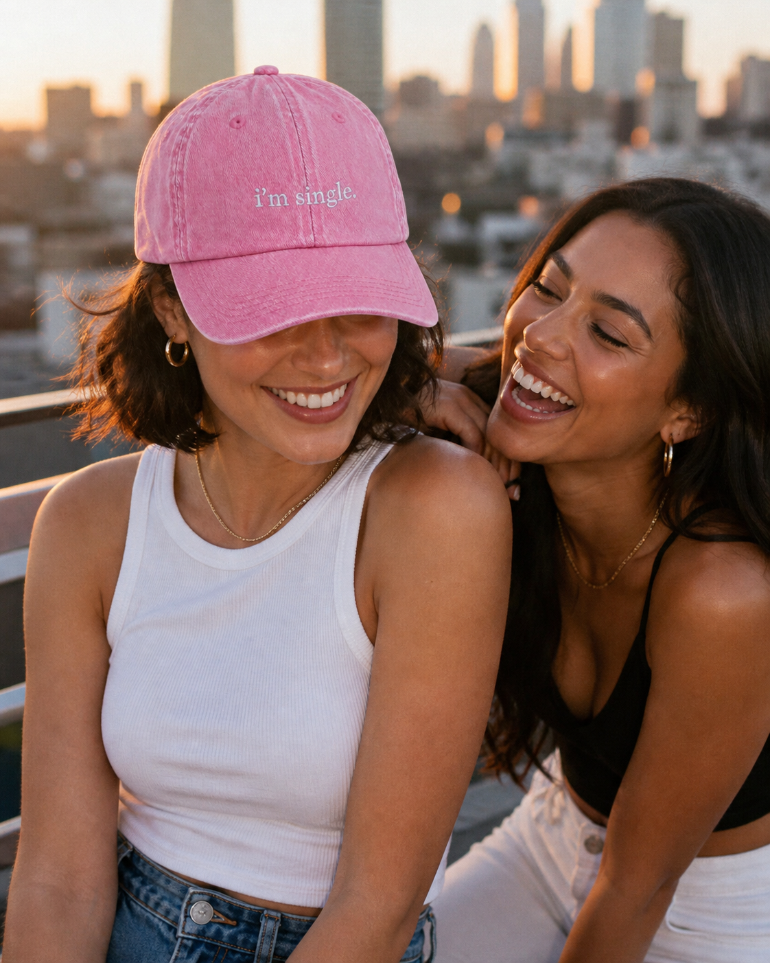 I'm Single cap in baby pink — washed cotton dad hat with “i'm single.” embroidered in white, worn