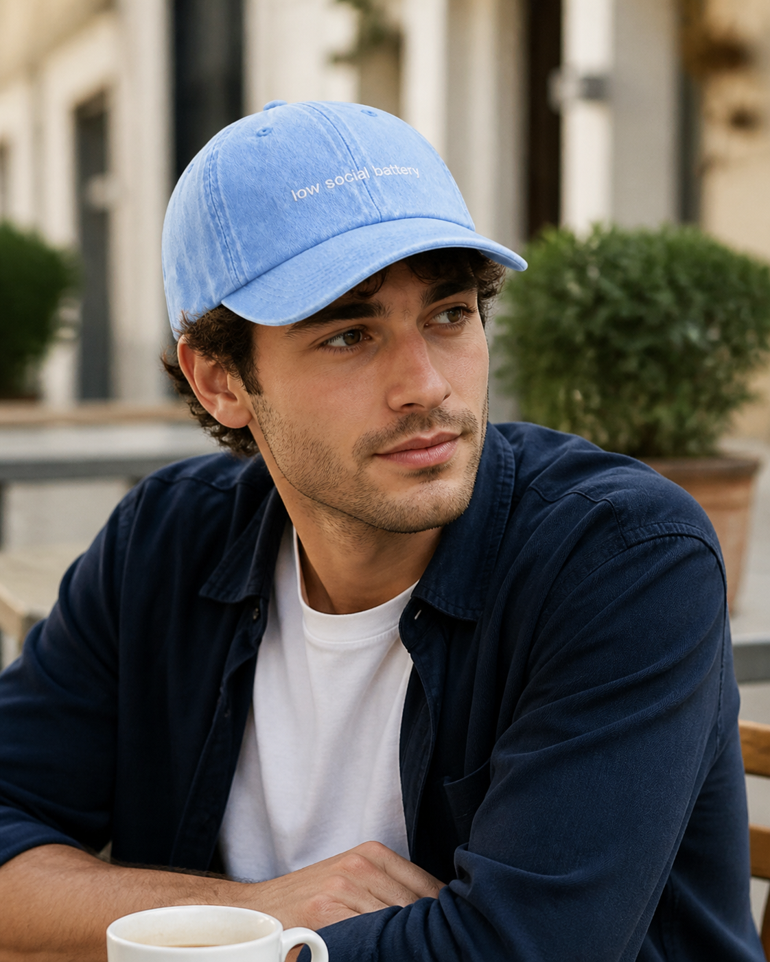 Low Social Battery cap in light blue — washed cotton dad hat with “low social battery” embroidered in white, worn
