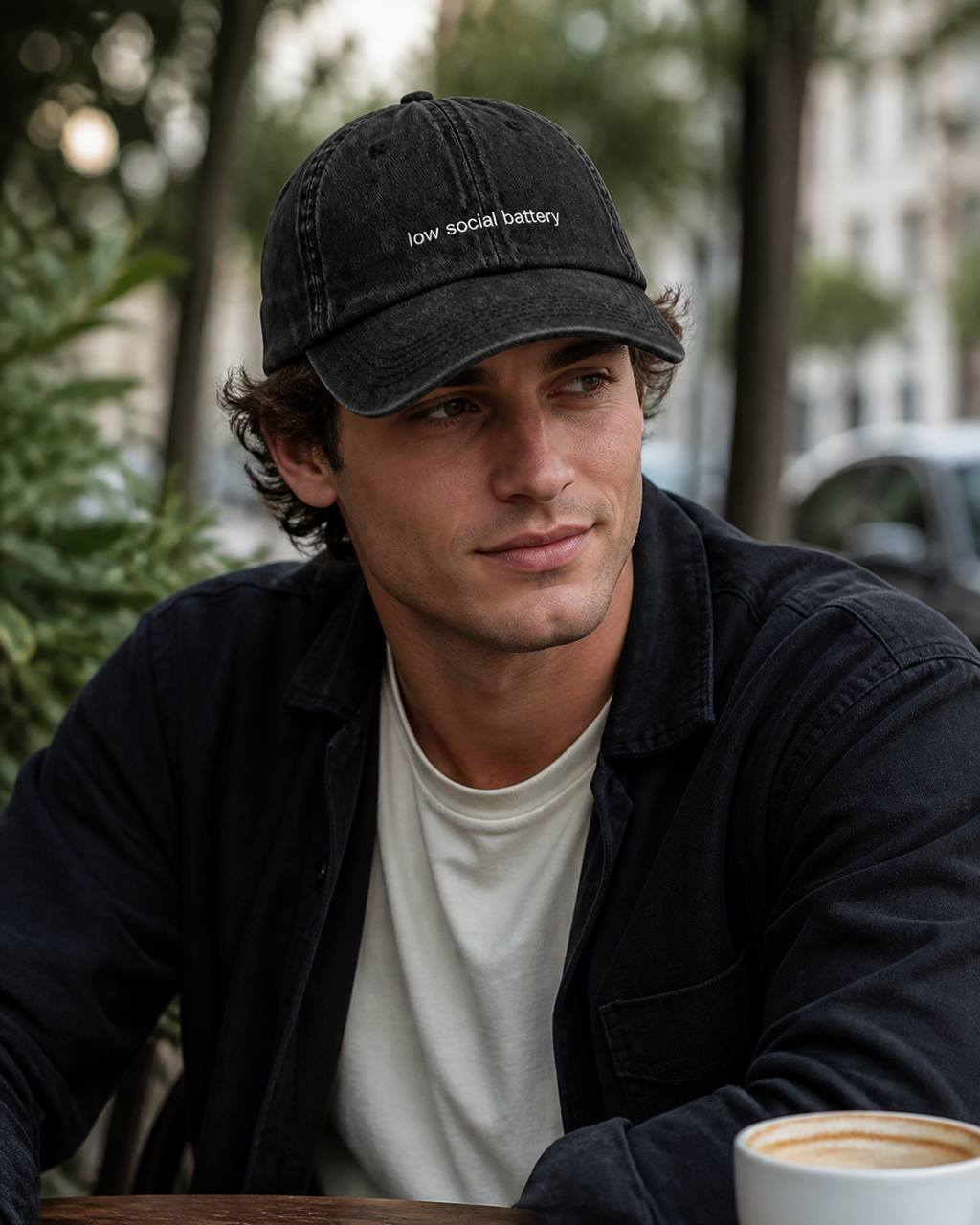 Low Social Battery cap in black — washed cotton dad hat with “low social battery” embroidered in white, worn