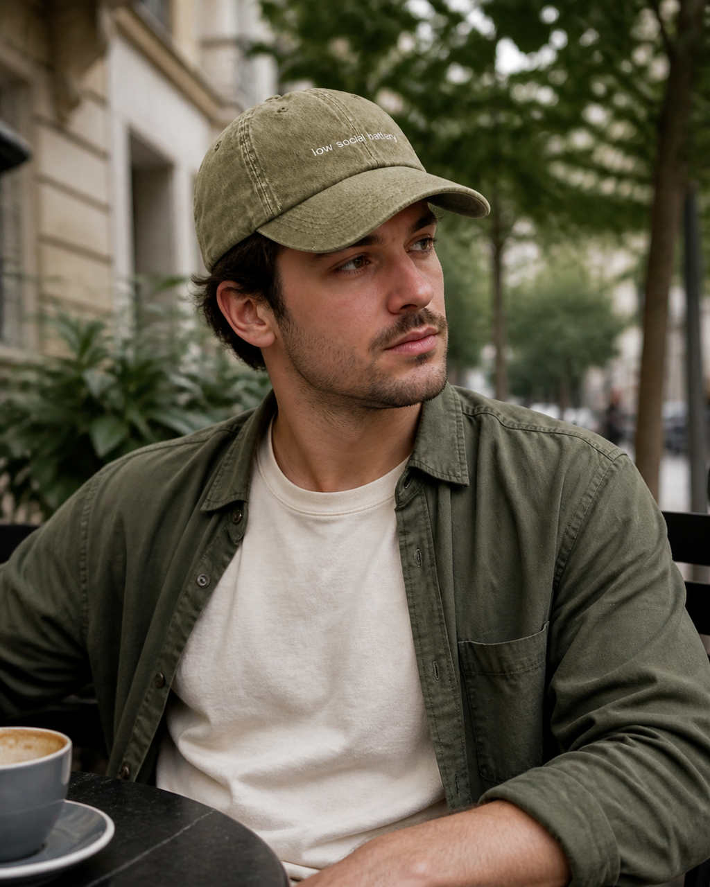 Low Social Battery cap in olive green — washed cotton dad hat with “low social battery” embroidered in white, worn