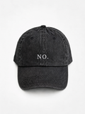 The washed black 'NO.' cap photographed flat and front-on, showing the white embroidered lettering across the front panel.