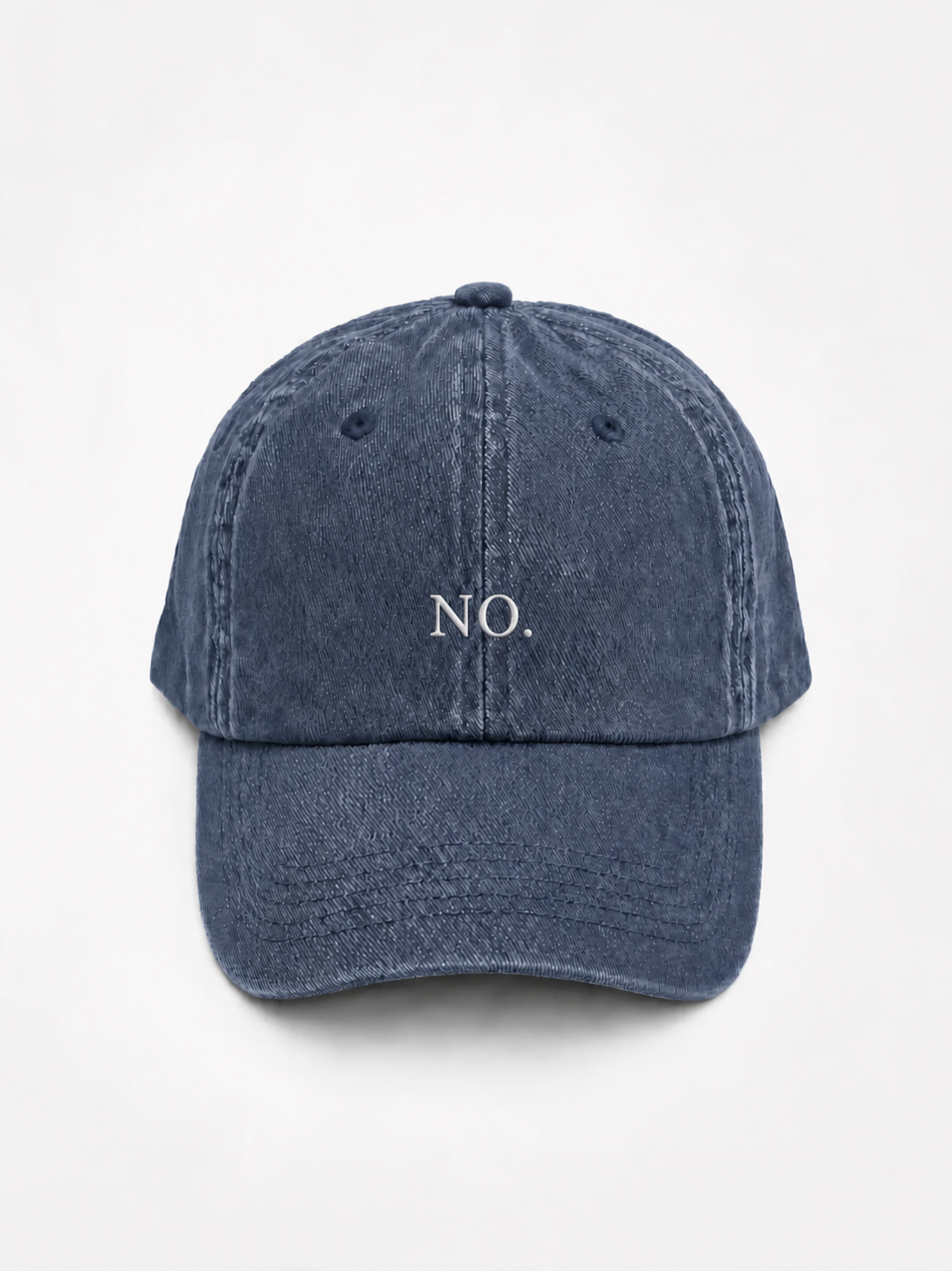 The washed navy 'NO.' cap photographed flat and front-on, showing the white embroidered lettering across the front panel.