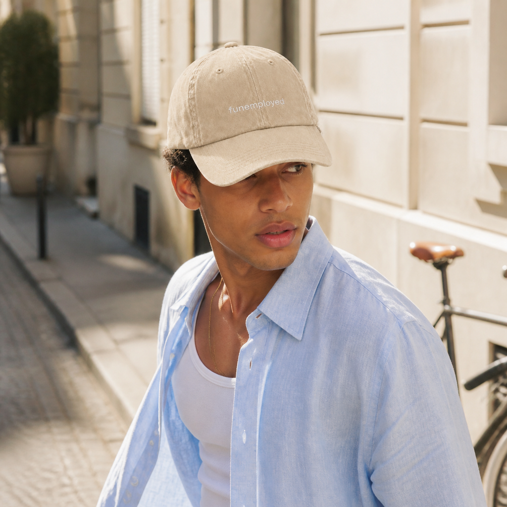 Funemployed cap in beige — washed cotton dad hat with “funemployed” embroidered in white, worn