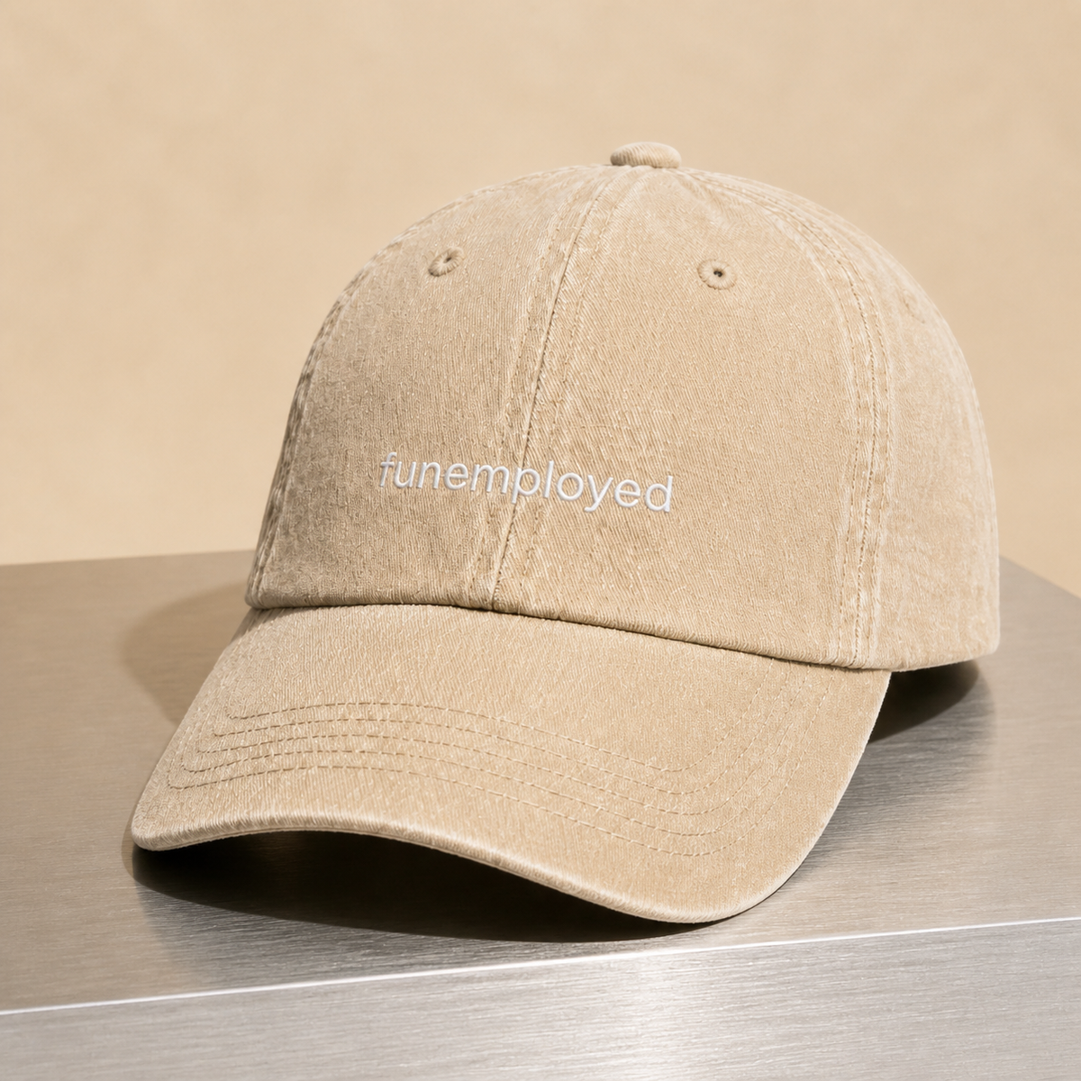 Funemployed cap in beige — washed cotton dad hat with “funemployed” embroidered in white, product shot
