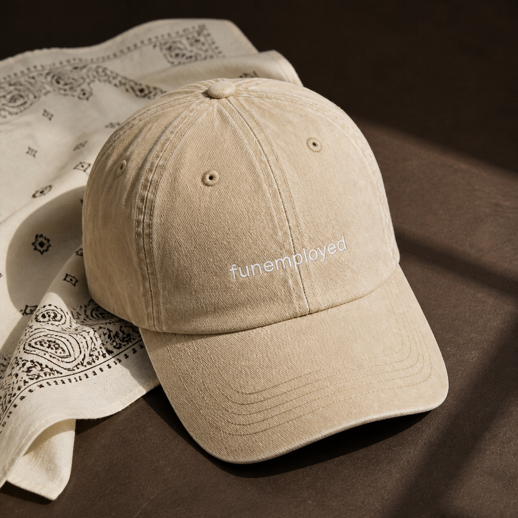 Funemployed cap in beige — washed cotton dad hat with “funemployed” embroidered in white, product shot