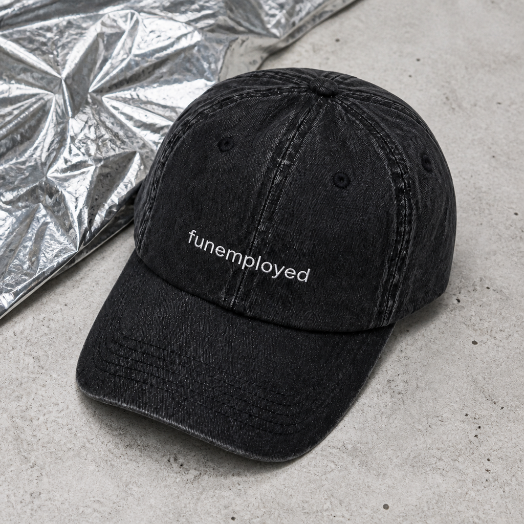 Funemployed cap in black — washed cotton dad hat with “funemployed” embroidered in white, product shot