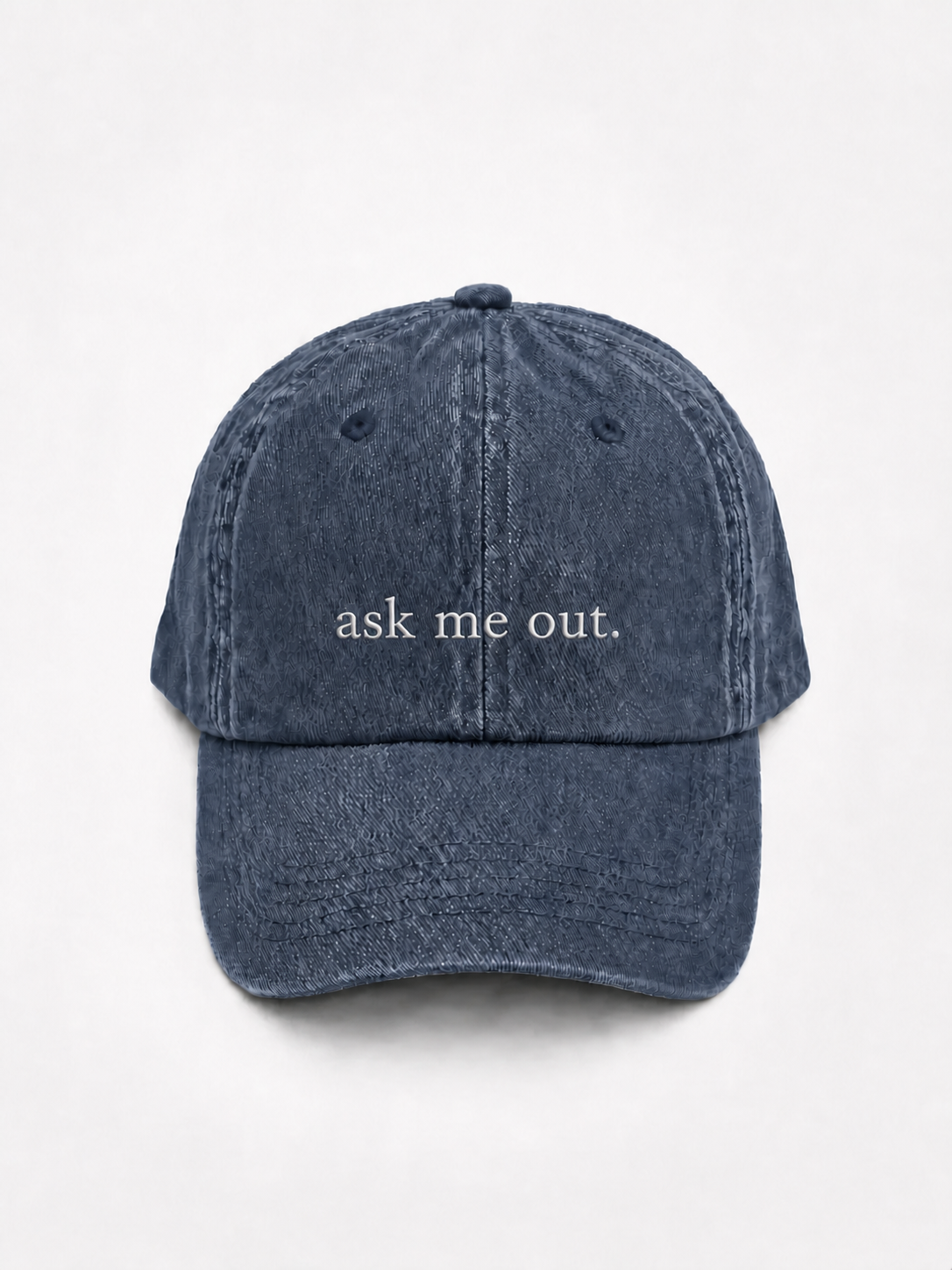 HERO-NAVY Washed navy six-panel baseball cap with 'ask me out.' embroidered in white serif lettering across the front, shown face-on against a plain white background.