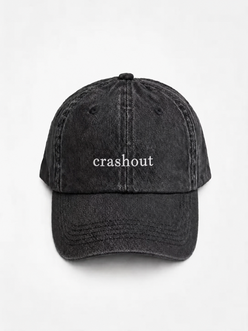 HERO-BLACK Washed black six-panel baseball cap with 'crashout' embroidered in white serif lettering across the front, shown face-on against a plain white background.