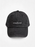 HERO-BLACK Washed black six-panel baseball cap with 'crashout' embroidered in white serif lettering across the front, shown face-on against a plain white background.
