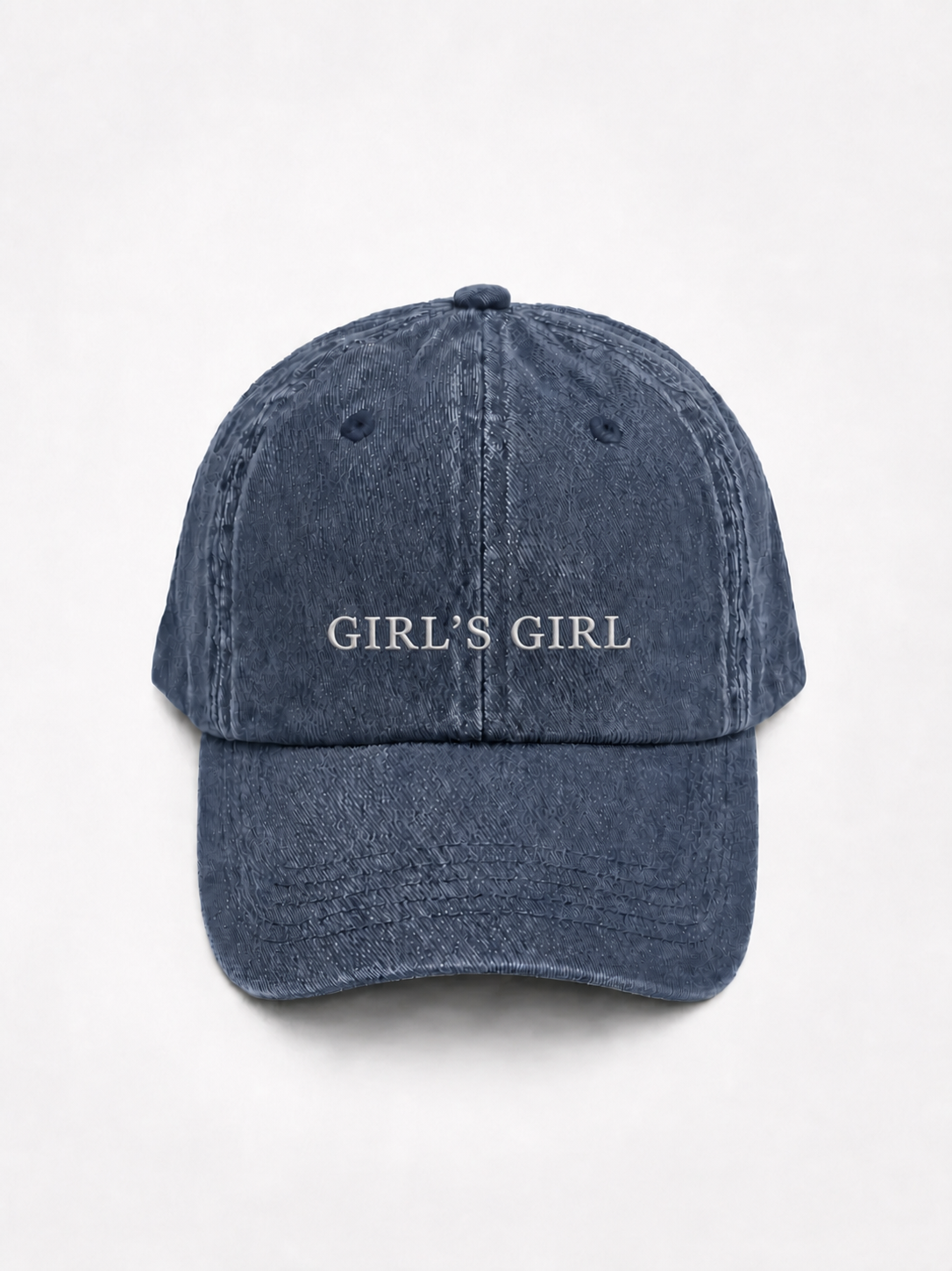 HERO-NAVY Washed navy six-panel baseball cap with 'GIRL'S GIRL' embroidered in white serif capitals across the front, shown face-on against a plain white background.