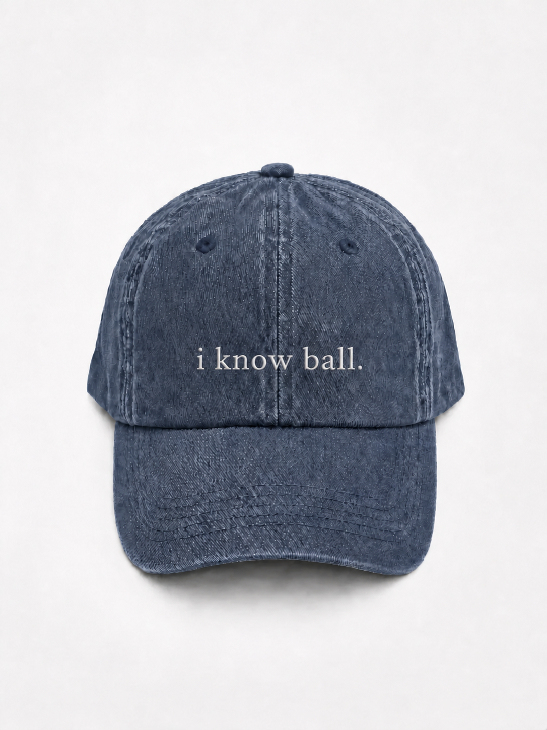 HERO-NAVY Washed navy six-panel baseball cap with 'i know ball.' embroidered in white serif lettering across the front, shown face-on against a plain white background.