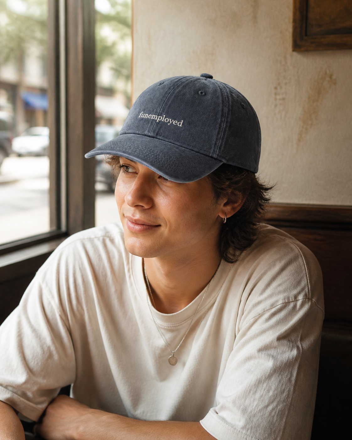 Funemployed cap in navy — washed cotton dad hat with “funemployed” embroidered in white, worn