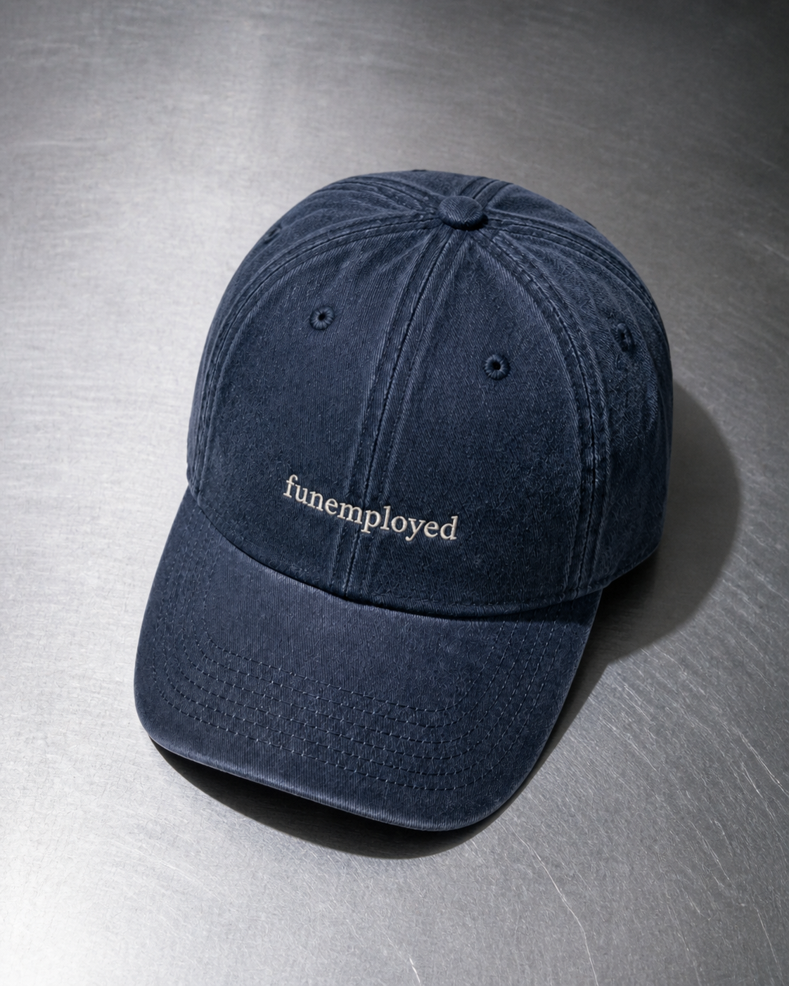 Funemployed cap in navy — washed cotton dad hat with “funemployed” embroidered in white, product shot