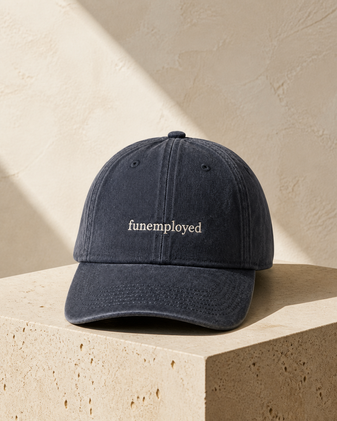 Funemployed cap in navy — washed cotton dad hat with “funemployed” embroidered in white, product shot