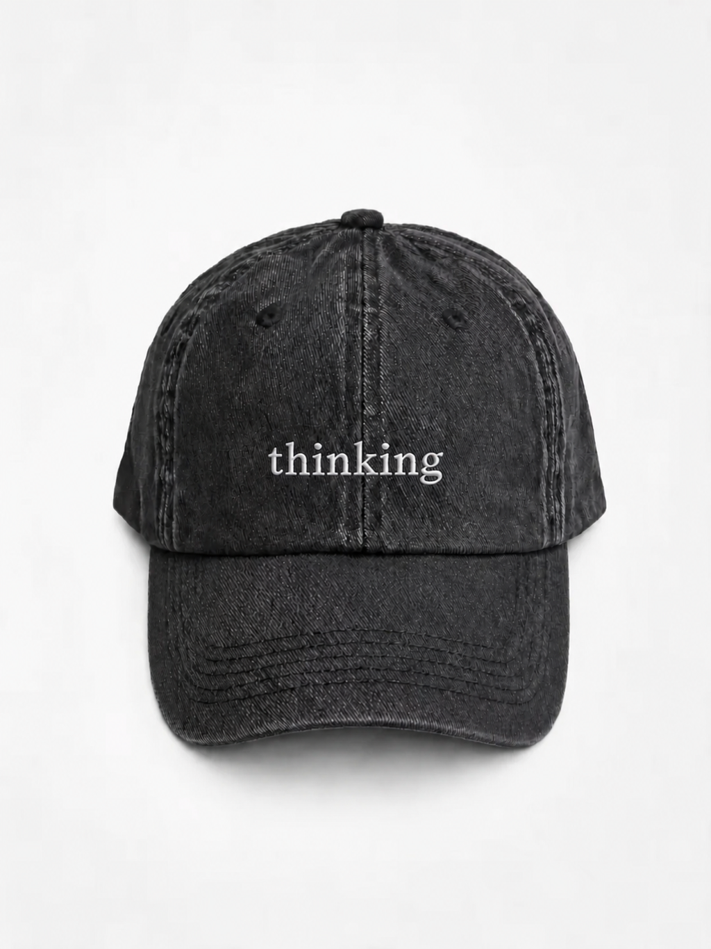 HERO-BLACK Washed black six-panel baseball cap with 'thinking' embroidered in white serif lettering across the front, shown face-on against a plain white background.