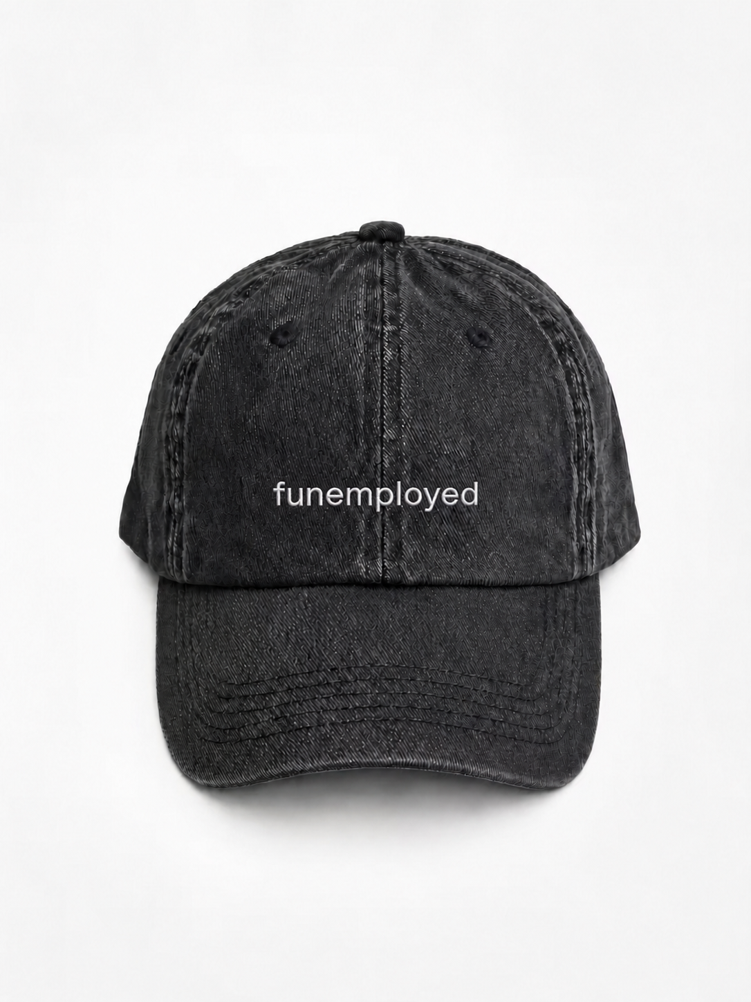A black washed cotton baseball cap with the word 'funemployed' printed in white lowercase letters on the front, shown against a plain white background.