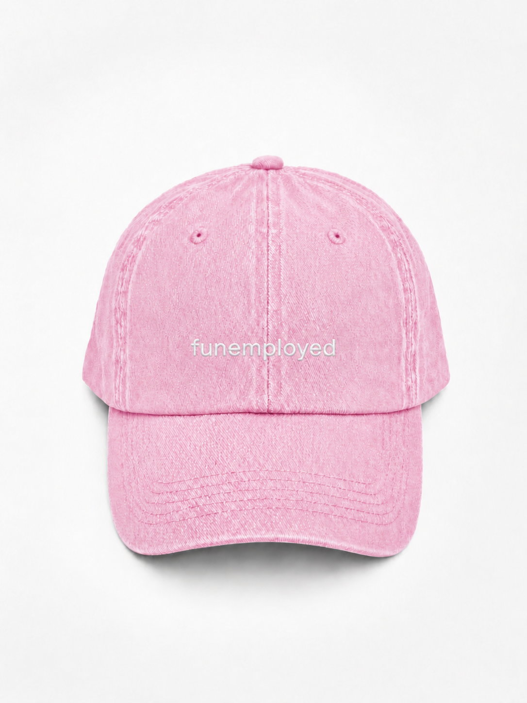 A pink washed cotton baseball cap with the word 'funemployed' embroidered in white across the front, shown against a plain white background.