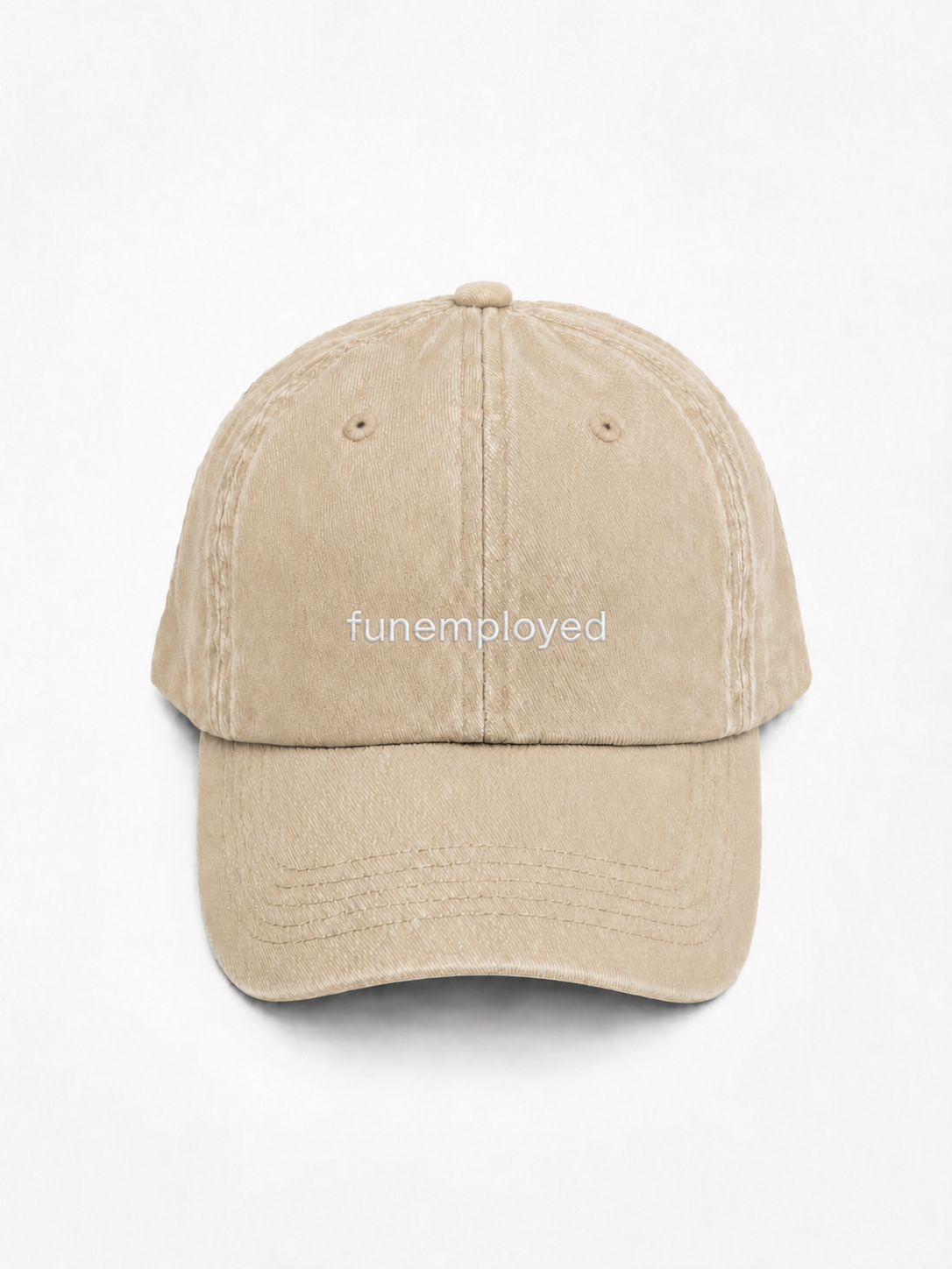 A beige washed cotton baseball cap with the word 'funemployed' printed in white lowercase letters on the front, shown against a plain white background.