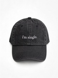A washed black baseball cap with the phrase 'i'm single.' embroidered in white on the front, shown against a plain white background.