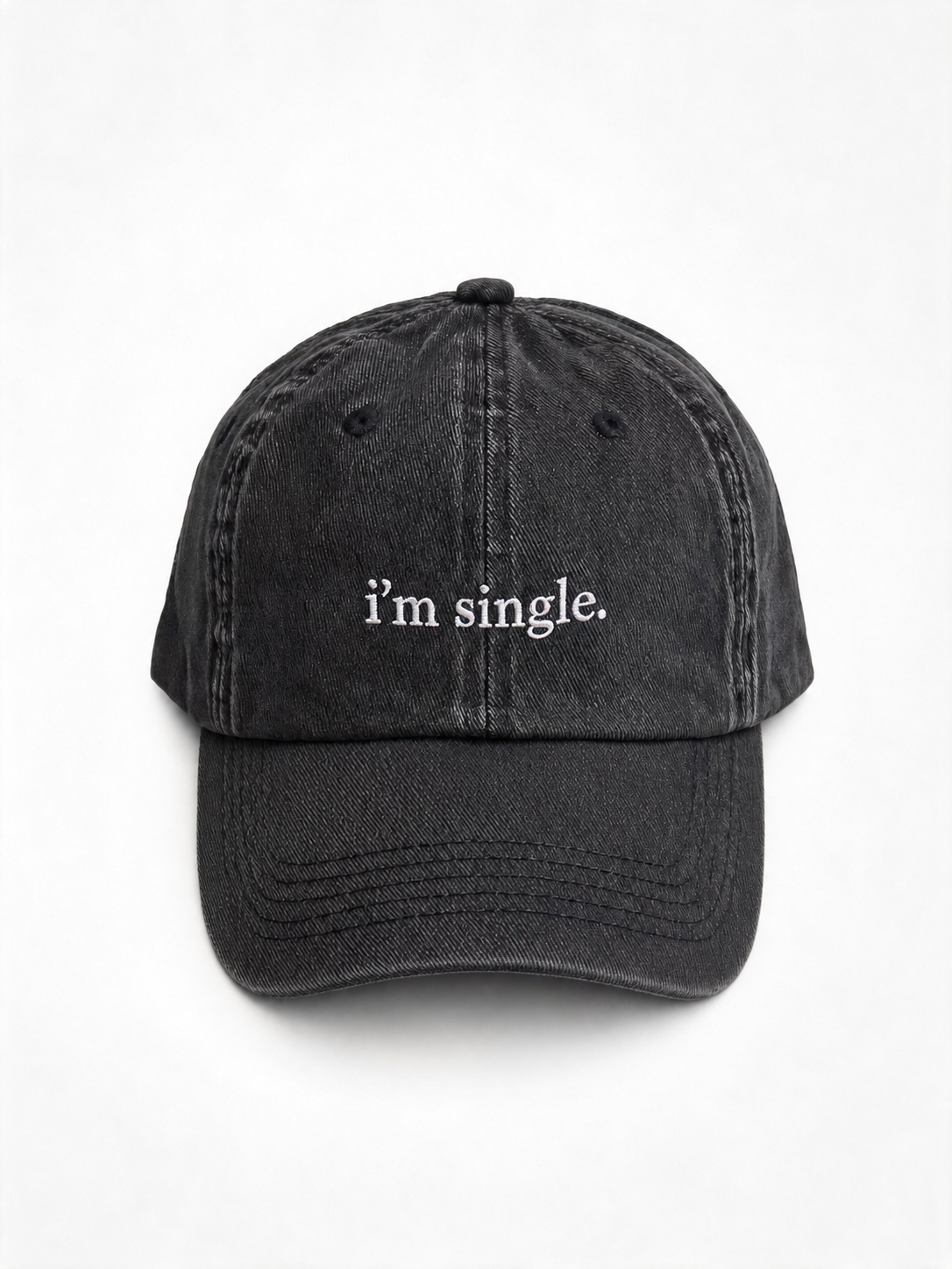 A washed black baseball cap with the phrase 'i'm single.' embroidered in white on the front, shown against a plain white background.