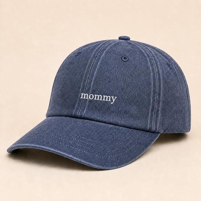 A blue denim-style baseball cap with the word 'mommy' embroidered in white lowercase letters on the front, shown on a plain beige background.