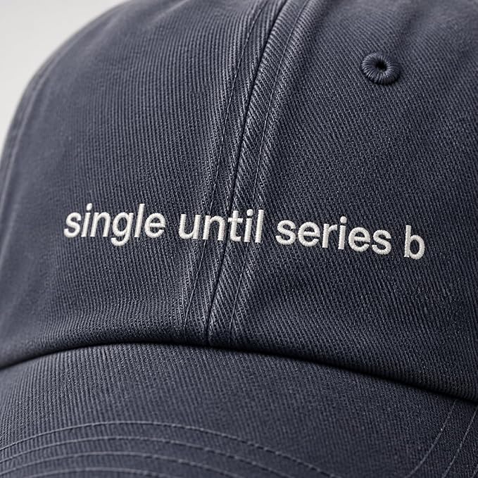 Close-up of a dark navy baseball cap with white embroidered text reading 'single until series b' on the front panel.