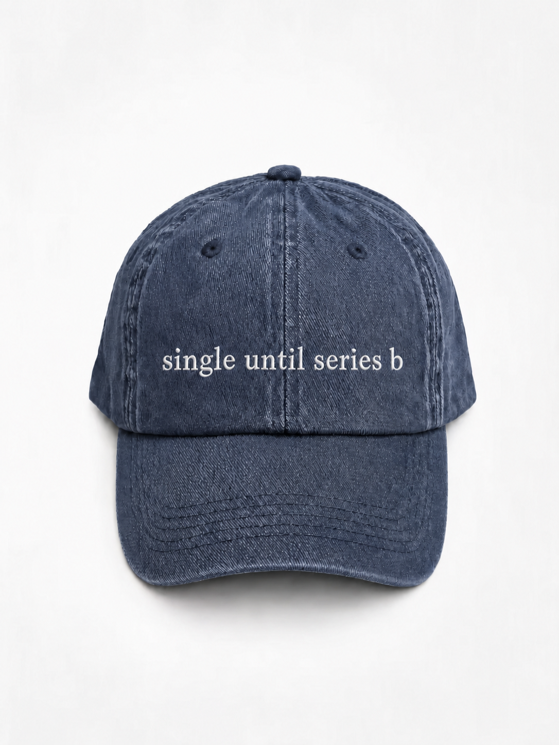 A washed navy blue baseball cap with the phrase 'single until series b' embroidered in white across the front, shown against a plain white background.