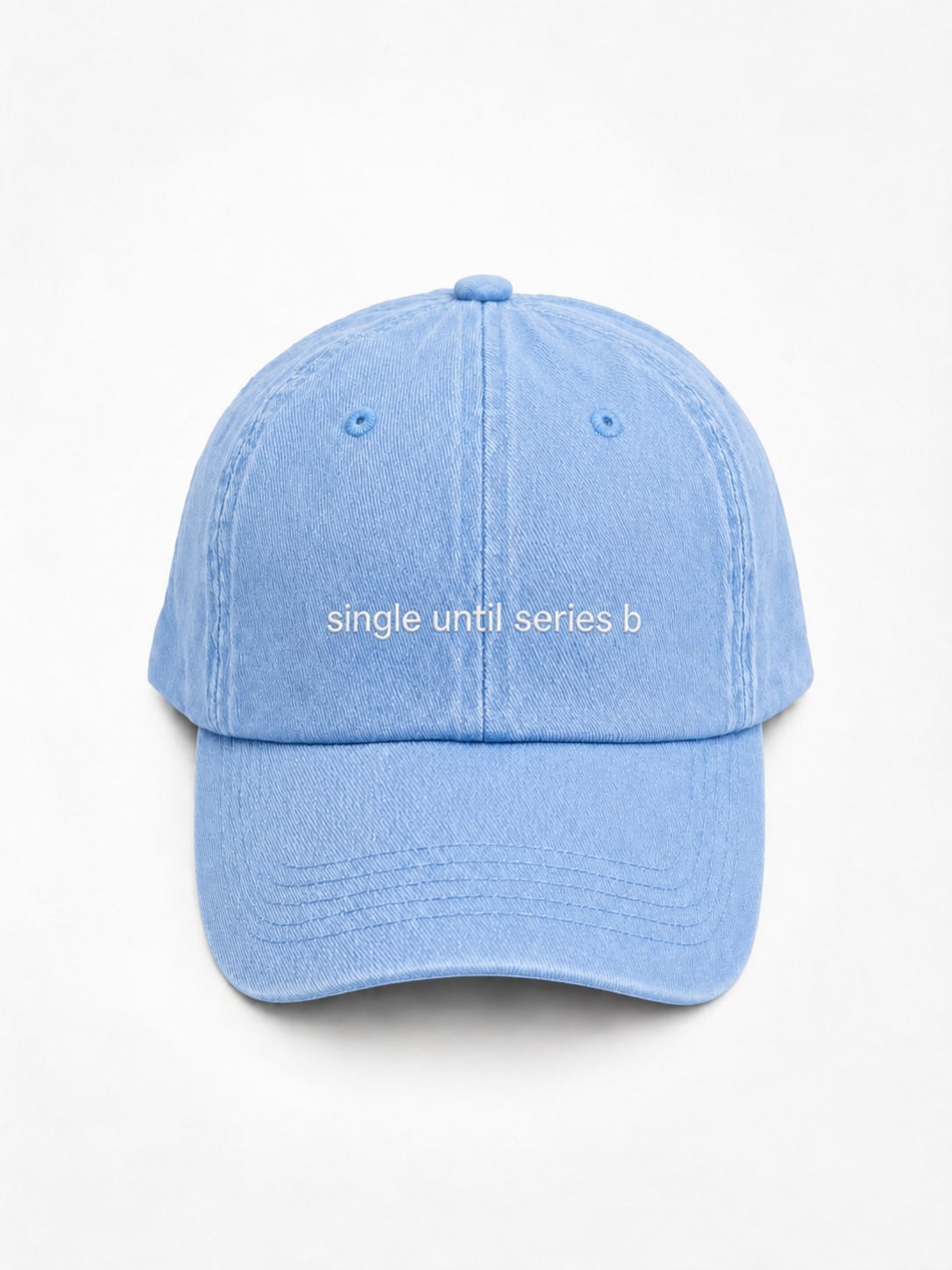 A light blue washed cotton baseball cap with the phrase 'single until series b' printed in white across the front, set against a plain white background.