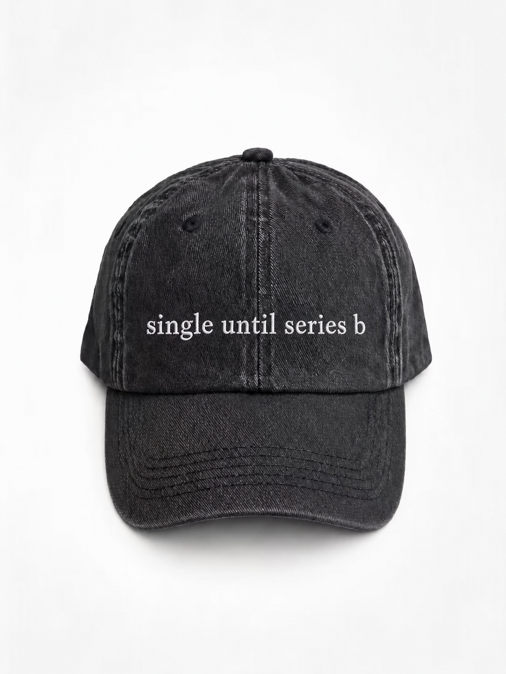 A washed black baseball cap with the phrase 'single until series b' embroidered in white across the front, shown against a plain white background.