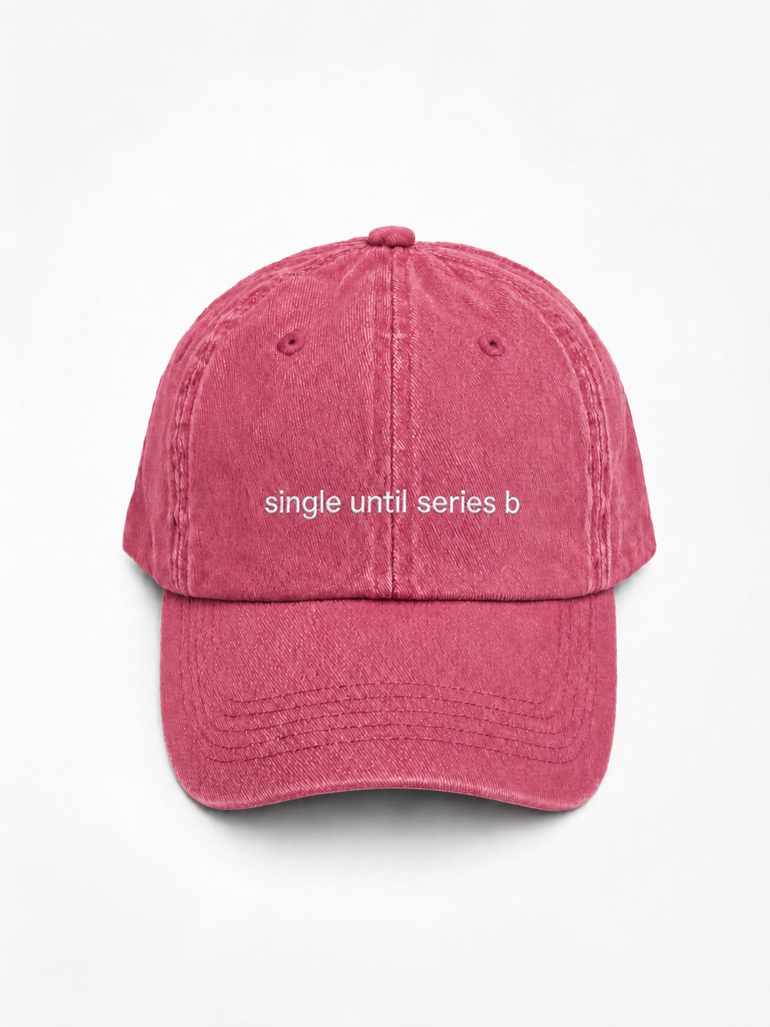A washed pink baseball cap with the phrase 'single until series b' printed in white lowercase letters across the front, shown against a plain white background.