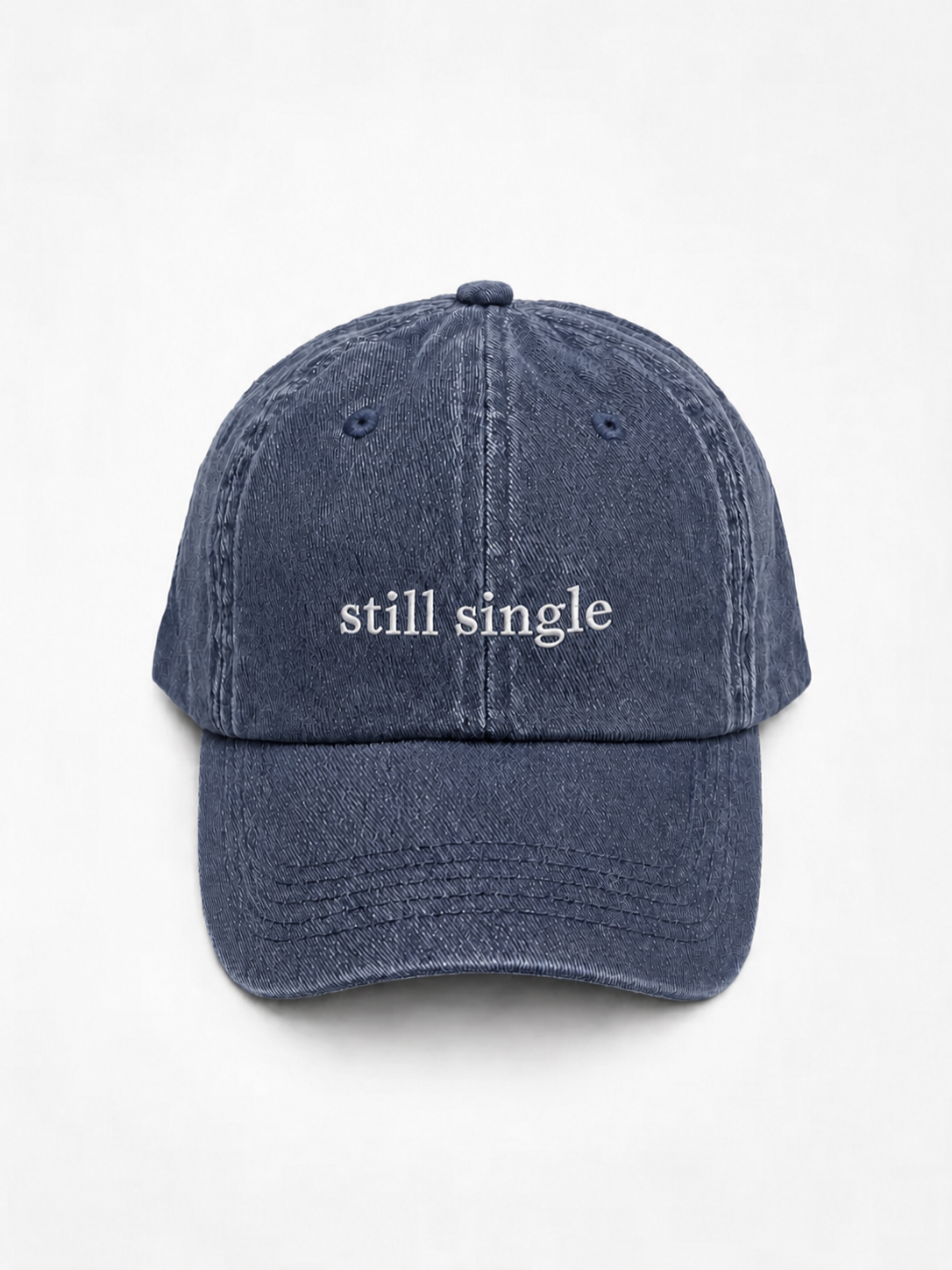 Still Single cap in navy — washed cotton dad hat with “still single” embroidered in white, product shot