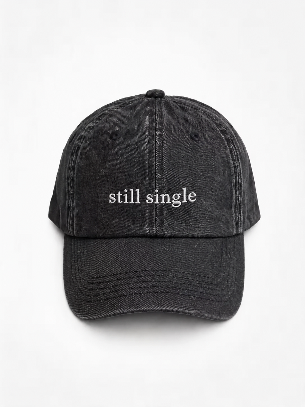 Still Single cap — washed cotton dad hat with “still single” embroidered in white, product shot