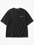 A black acid-wash short-sleeve t-shirt with 'i'm single.' printed in white script on the left chest, displayed flat against a clean white background.