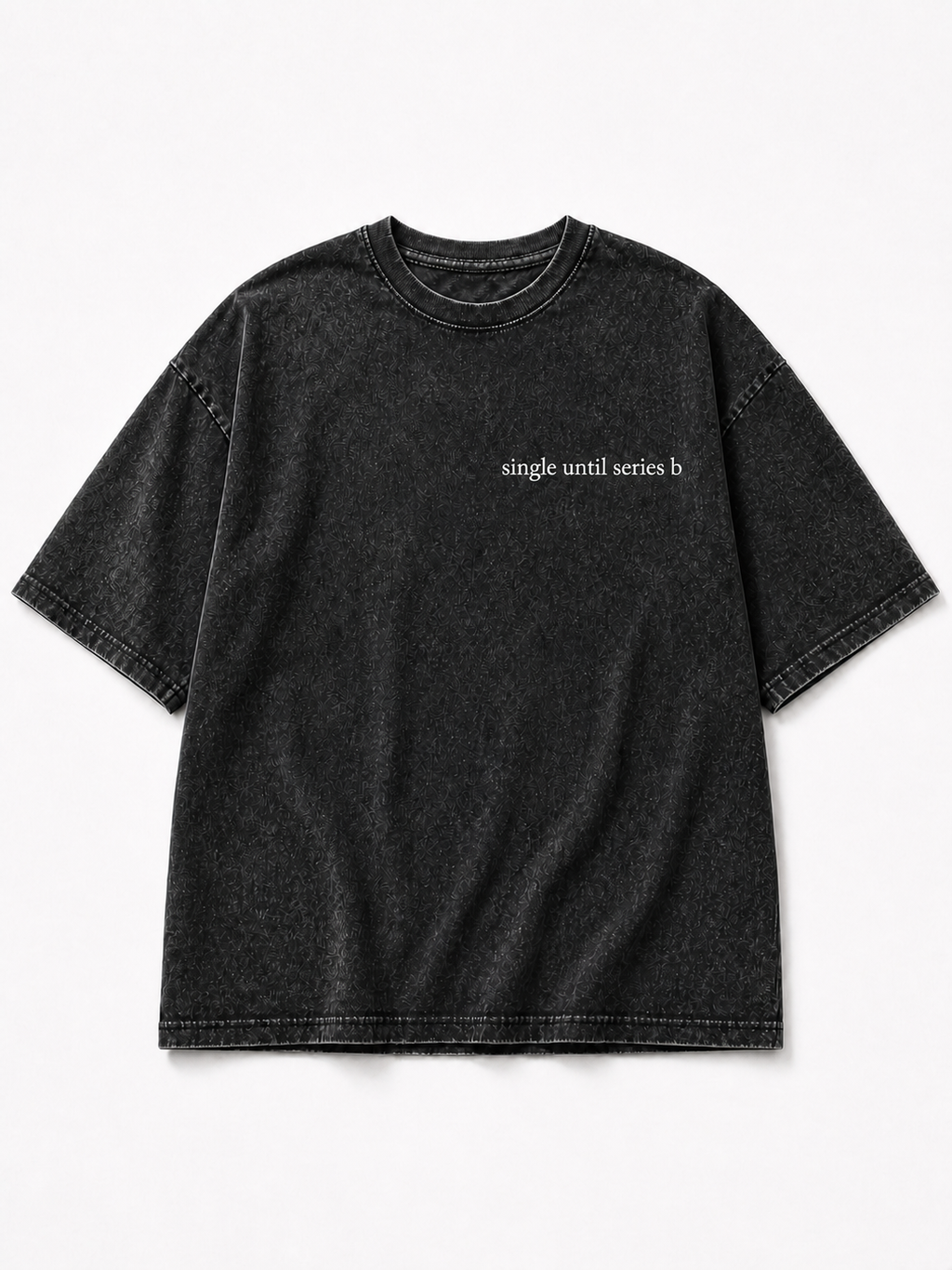 A washed black short-sleeve t-shirt with the phrase 'single until series b' printed in small white text on the left chest, displayed flat against a light gray background.
